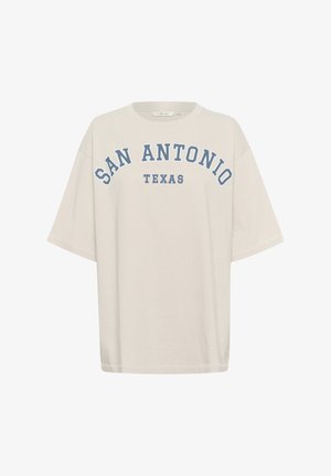 Krém színű, rövid ujjú póló, amelyen világoskék színnel a "SAN ANTONIO TEXAS" felirat található. Lazább szabású és kerek nyakú. Puha tapintású.
