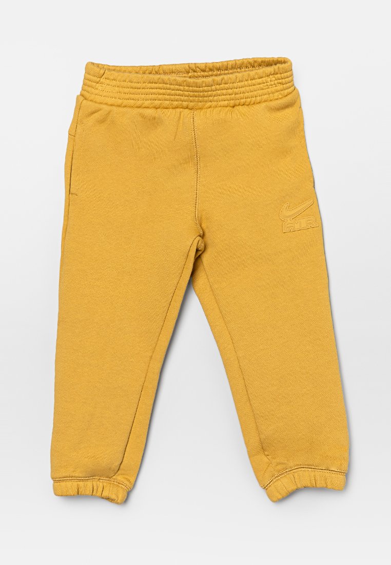Pantalons de survêtement jaunes avec taille élastique, ourlets à côtes et logo Nike imprimé sur le devant. Fabriqués en tissu doux et texturé avec des poches latérales.