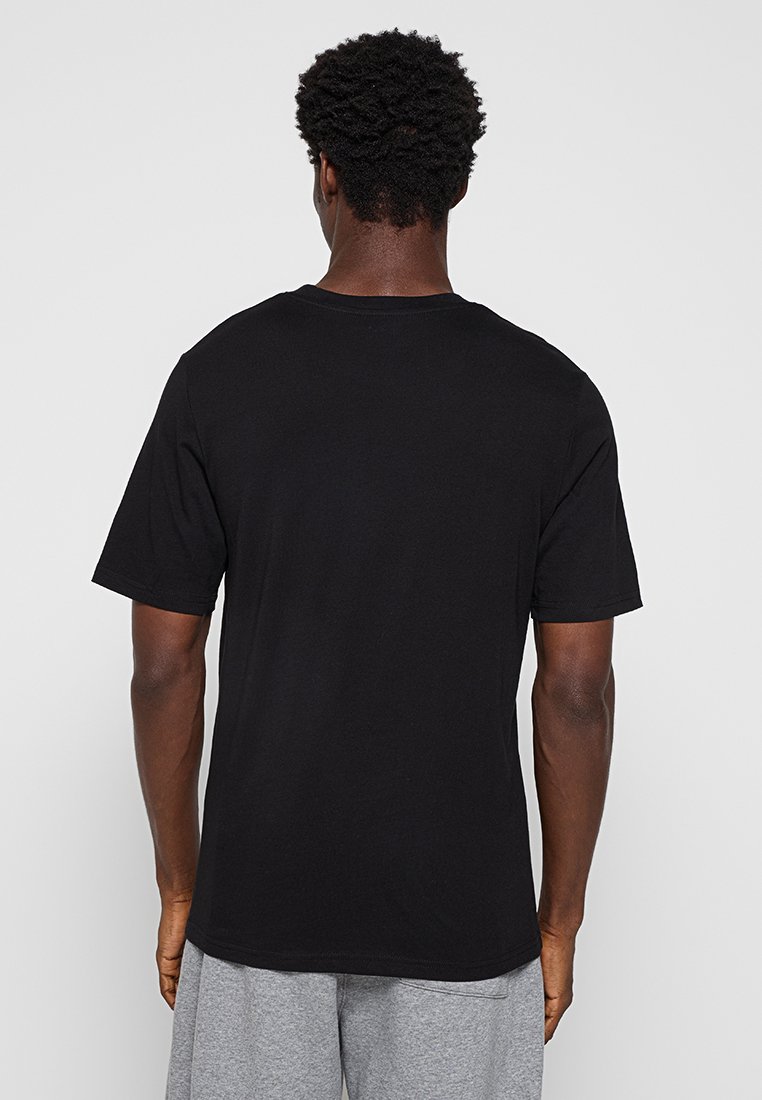 Schwarzes Baumwoll-T-Shirt mit kurzen Ärmeln, Rundhalsausschnitt und lockerer Passform, sichtbare Steppnähte entlang des Ausschnitts und der Ärmel.