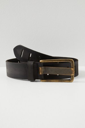 Black leather belt rolled with aged brass rectangular buckle and multiple adjustment holes on white surface.