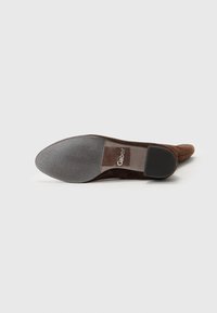 Brown suede shoe with a pointed toe, sleek design, textured rubber sole, and a small heel. Gabor branding visible on the side.