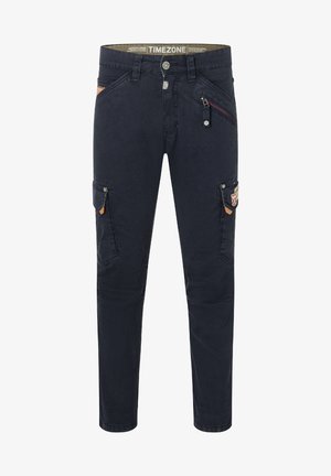 Navy blue cargo pants with a slim fit, featuring multiple pockets, a zippered pocket, and contrasting tan accents. Cotton blend material.