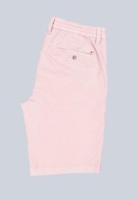 Light pink cotton shorts with a flat front and an elastic waistband. Features a back pocket with a button closure and subtle logo detail.