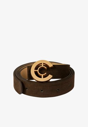 Brūna zamšādas josta ar lielu zelta apaļu sprādzi ar izgriezuma dizaina elementiem. Siksnai ir vairāki caurumi izmēra regulēšanai.