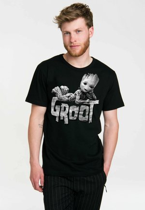 Black cotton t-shirt featuring a graphic of a character with a wooden texture, accompanied by the word "GROOT" in a distressed style.