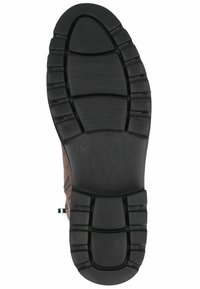 Semelle de chaussure en caoutchouc noir avec un motif texturé et des rainures de flexion, présentant une forme arrondie et une indication de taille 37.