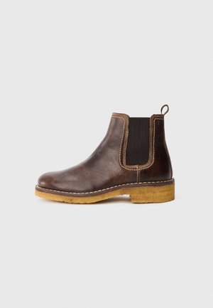 Brown leather Chelsea boot with elastic side panel, contrasting stitching, and a beige, textured sole. Rounded toe and heel tab for easy wear.