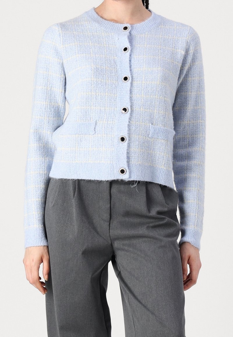 Cardigan bleu clair à motif à carreaux, col rond, fermeture à boutons sur le devant et deux poches avant, fabriqué en tissu tricoté texturé.