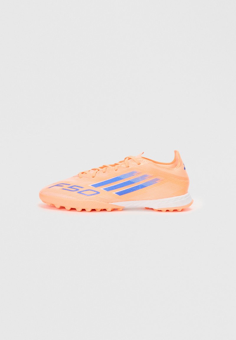 Orange soccer shoes with blue accents, textured upper, and a lightweight design. Features a lace closure and traction-focused sole.