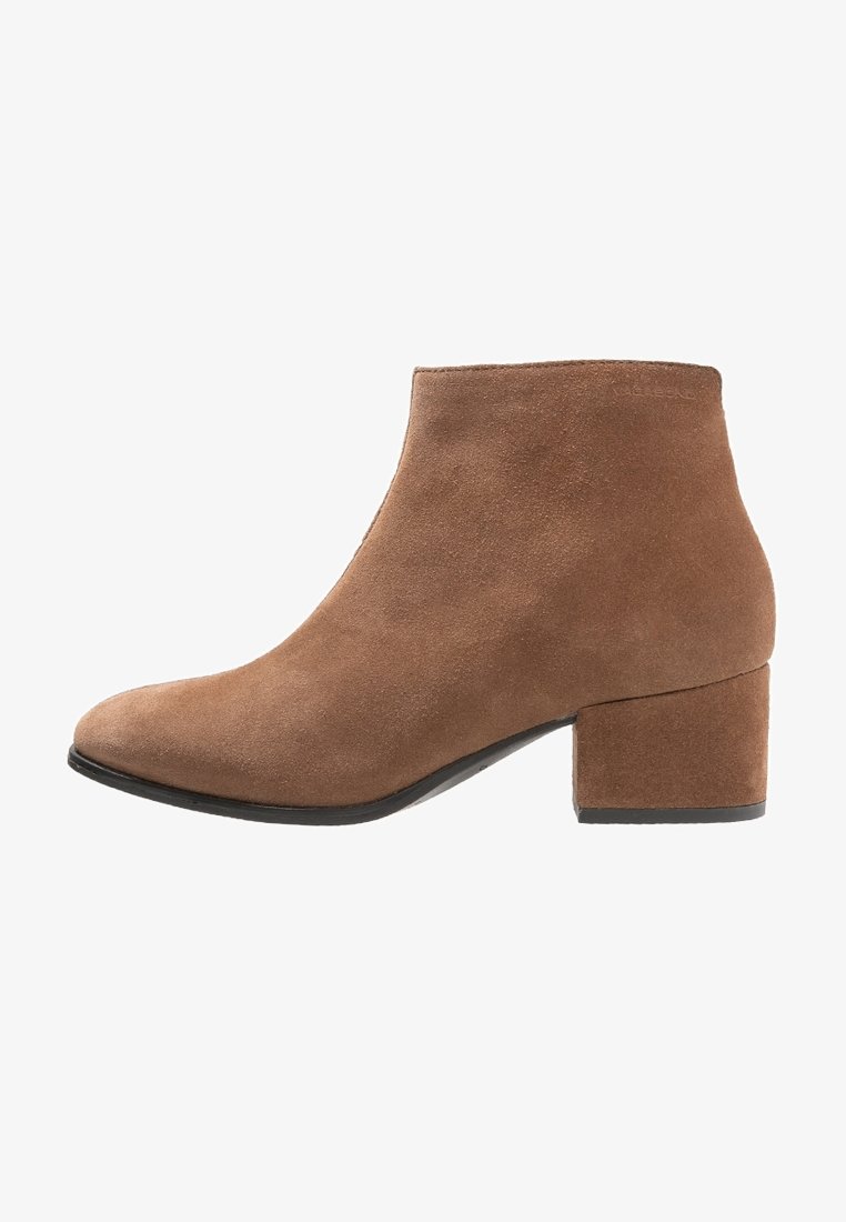 Brown suede ankle boot with block heel, rounded toe, and smooth texture, shown from the side on a white background.