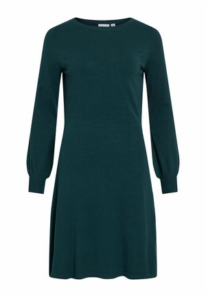 Tirkīza krāsas garo piedurkņu kleita ar apaļu kakla izgriezumu, izplešamu svārku un ribotām aprocēm. Izgatavota no mīksta dzijas materiāla, tai ir vienkāršs un tīrs dizains.