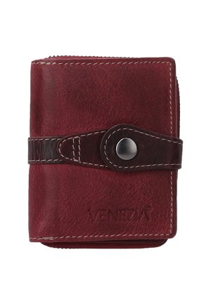 Red leather wallet with a zip closure, secured by a dark brown strap and silver snap button, featuring embossed brand name on the front.