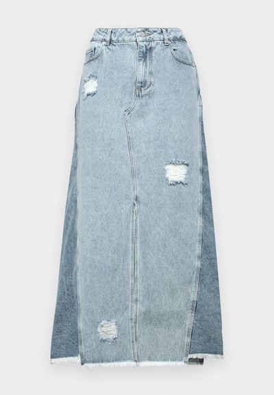 Denim skirt featuring a blend of light and dark blue fabrics, distressed patches, a high waist, and a frayed hem.