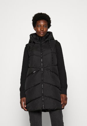 Gilet rembourré noir avec capuche, doté de poches zippées, de manches en tricot texturé et de surpiqûres en chevron sur le corps.