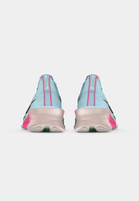 Blue athletic shoes with pink and green accents, featuring a textured fabric upper, cushioned soles, and a streamlined design.