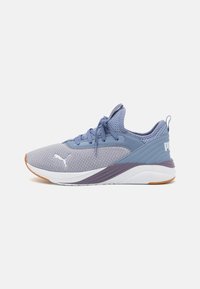 Light blue athletic shoes with mesh upper, textured accents, lace-up closure, and white sole featuring purple details and logo.