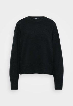 Pull en maille noir avec un col rond, des épaules tombantes et des manches longues. Doté d'un tissu texturé et d'une coupe cropped.
