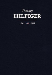 Navy blue cotton T-shirt featuring white text "Tommy HILFIGER" and "Est. 1985," with a small flag logo underneath. Smooth texture.