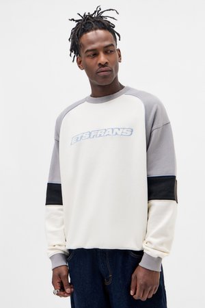 Kremowy sweatshirt z szarymi rękawami i czarnymi akcentami. Na przodzie znajduje się niebieski napis "ETS FRANS". Wykonany z miękkiego materiału z ściągaczami przy mankietach.