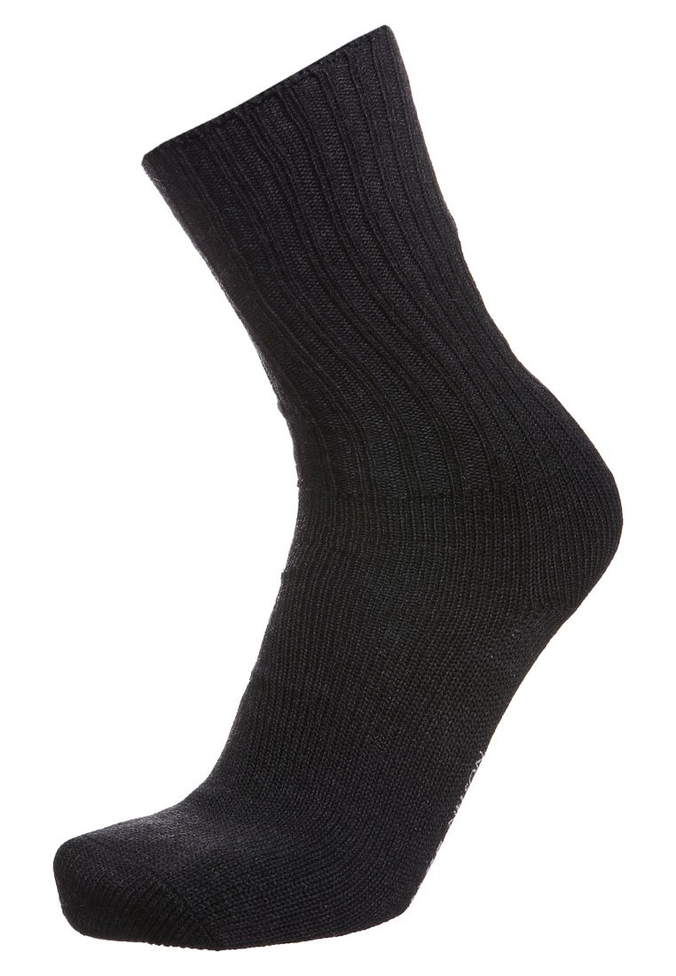 Calcetín negro de canalé con longitud hasta la mitad de la pantorrilla, con una textura suave y puntera reforzada. El tejido parece elástico y duradero.