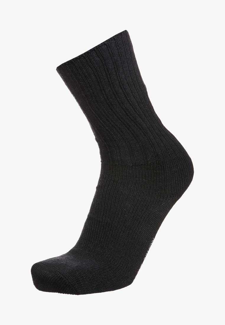 Calcetín negro de canalé con longitud hasta la mitad de la pantorrilla, con una textura suave y puntera reforzada. El tejido parece elástico y duradero.