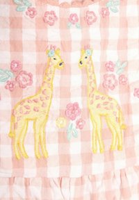 Pink gingham fabric features two embroidered giraffes and floral motifs in yellow, pink, and blue, with ruffled top and gathered bottom.