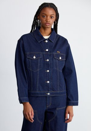 Denim jacket in dark blue with a boxy shape, featuring silver buttons, two chest pockets, and orange stitching accents.