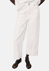 White wide-leg trousers with a cropped length, featuring a high waist, button closure, and cuffed hem. Made from durable fabric.