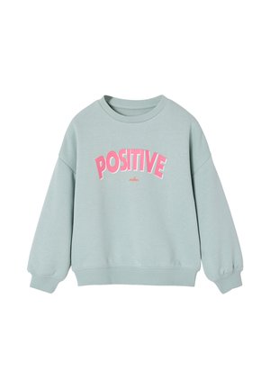 Light green sweatshirt with long sleeves and pink text "POSITIVE" curved across the chest, small red word "vibes" below.