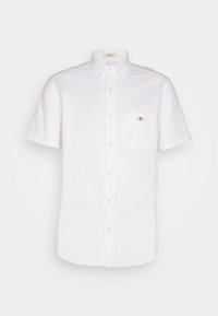 Biała koszula z krótkim rękawem zapinana na guziki, z kołnierzykiem zapinanym na guziki i małym haftowanym logo na lewej kieszeni na piersi.