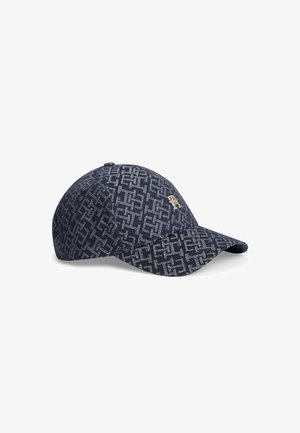 Marineblauwe honkbalpet met herhalend wit geometrisch patroon en een klein goudkleurig embleem aan de voorkant, met een gebogen klep.