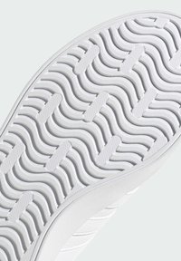 White rubber sole with a textured, wave pattern and small rectangular accents. Features a clean, smooth design with a rounded edge.