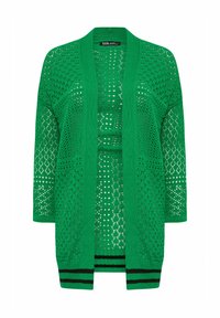Grön öppetstickad cardigan med lös passform, långa ärmar och svarta ränder vid fållen. Mönstret inkluderar diamant- och cirkelutskärningar.