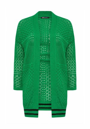 Green open-knit cardigan featuring a loose fit, long sleeves, and black stripes at the hem. Pattern includes diamond and circular cutouts.