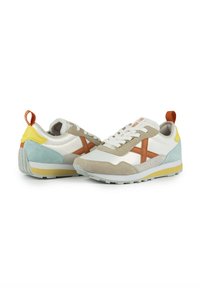 Multicolored sports shoes featuring a mix of white, beige, light blue, and yellow. Designed with suede and mesh materials; textured sole.