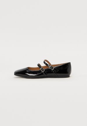Black patent leather flat shoe with a pointed toe, two buckled straps across the vamp, and a low, rounded heel.