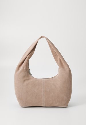 Hobo bag made of soft, suede material in a light beige color. Features a rounded shape with a wide strap and zip closure.