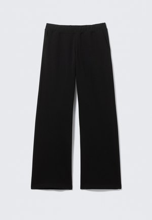 Μαύρο παντελόνι από μαλακό ύφασμα, με ευρύ στυλ ποδιού, ελαστική μέση και πλαϊνές τσέπες. Χωρίς ορατά σχέδια ή διακοσμήσεις.