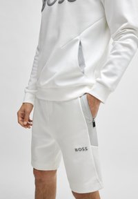 BOSS HEADLO - Spodnji deli trenirk - white