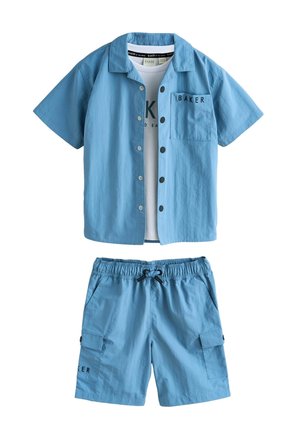 Lyseblå kortærmet skjorte med knapper og matchende shorts med elastisk talje, sort snøre og påsyede lommer, parret med en hvid undertrøje.