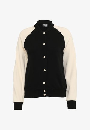 Sort og creme varsity-jakke med knaplukning fortil, ribbede manchetter og en rund krave. Har kontraststribede raglanærmer og sidelommer.