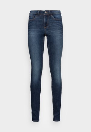 Slim fit jeans van donker denim met een lichte vervaging. Beschikt over een klassiek vijf-pocket ontwerp, knoopsluiting en smalle pijpopeningen.