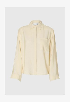 Gelbes, langärmliges Hemd aus weichem Stoff. Mit einem Kragen, vorderer Druckknopfverschluss und einer Brusttasche auf der linken Seite. Bequeme Passform.