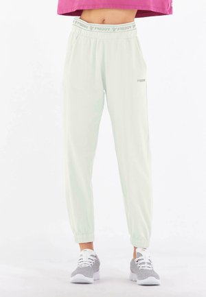 Hellgrüne Jogginghose mit elastischem Bund und Bündchen. Mit Seitentaschen und einem Logo am linken Bein. Weicher Stoff.