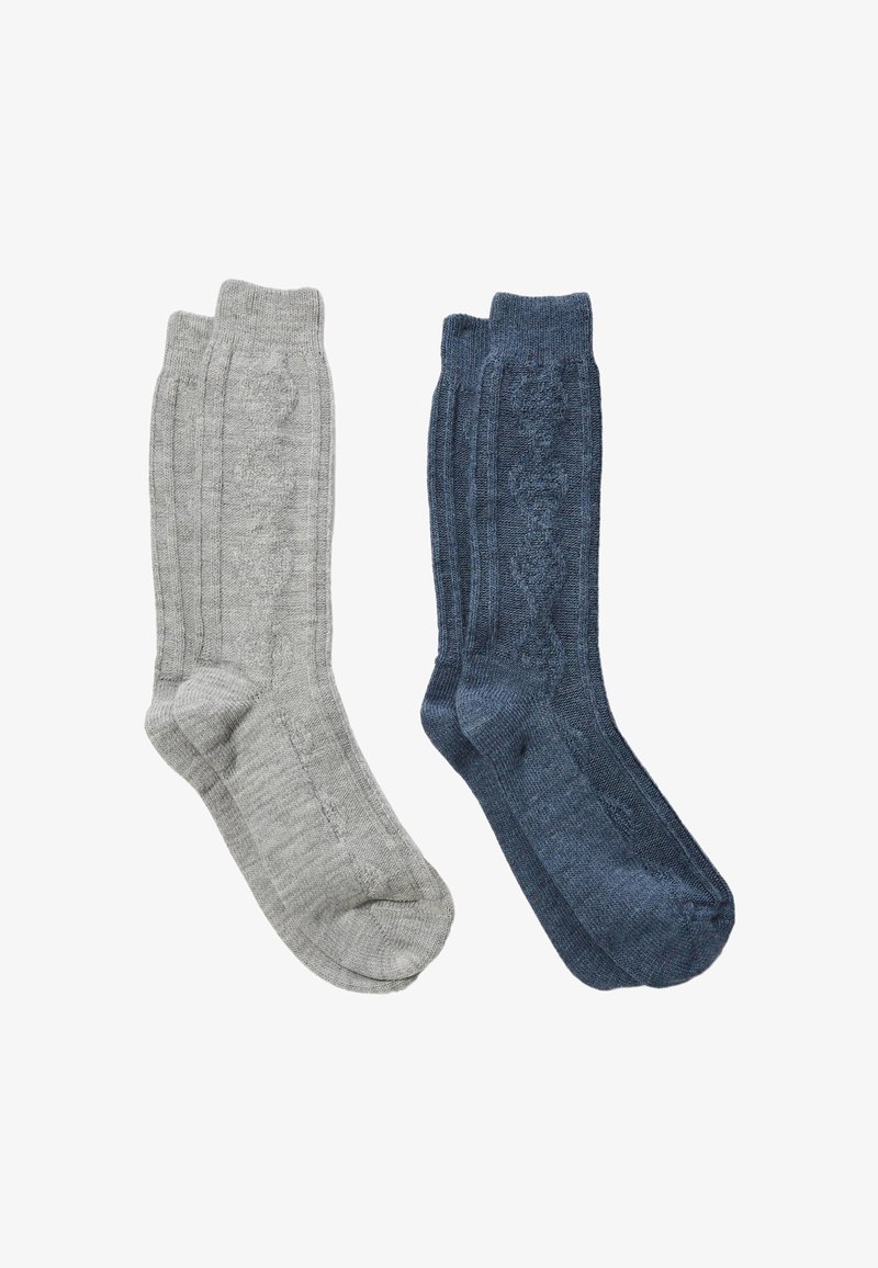 Deux paires de chaussettes montantes : une grise avec une texture côtelée, l'autre bleu foncé avec un motif torsadé.