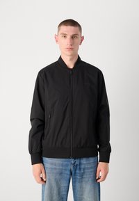 Black bomber jacket with a zip front, ribbed cuffs, and two side pockets. Made of smooth, lightweight fabric.