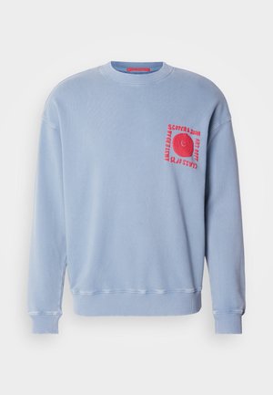 Light blue sweatshirt with long sleeves, crew neck, and ribbed cuffs. Features a red embroidered graphic on the chest pocket area.