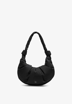 Borsa a tracolla in tessuto morbido nero a forma di mezzaluna con tracolla imbottita e piccolo logo "GOT BAG." al centro in basso.