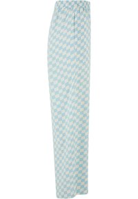 Pantalon ample à carreaux bleu clair et blanc avec taille élastique et poches latérales, vu de côté.