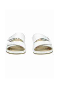 White slide sandals with two adjustable straps, curved cutouts, textured insole, and minimalistic design. Soft synthetic material.